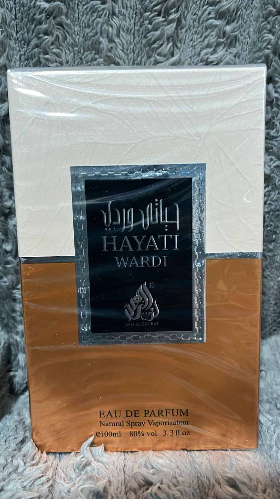 Hayati Wardi Eau de Parfum packaging on a textured gray surface