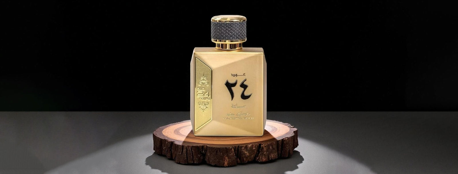 Gold perfume bottle with black text on a dark background