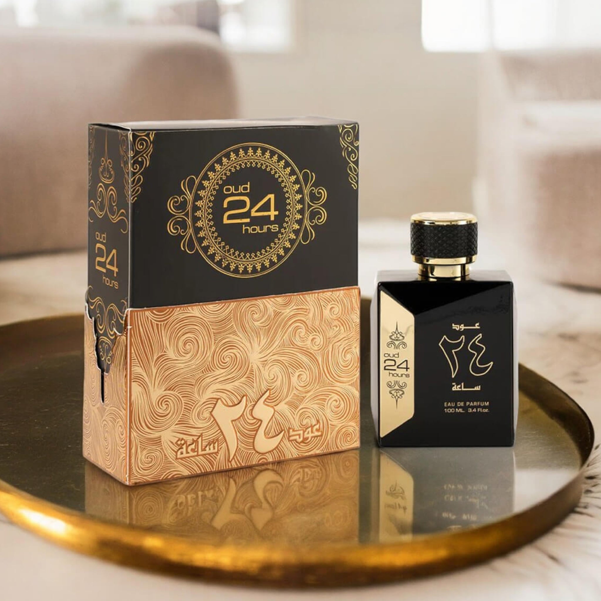 Perfume bottle and packaging with 'Oud 24' branding on a reflective surface.