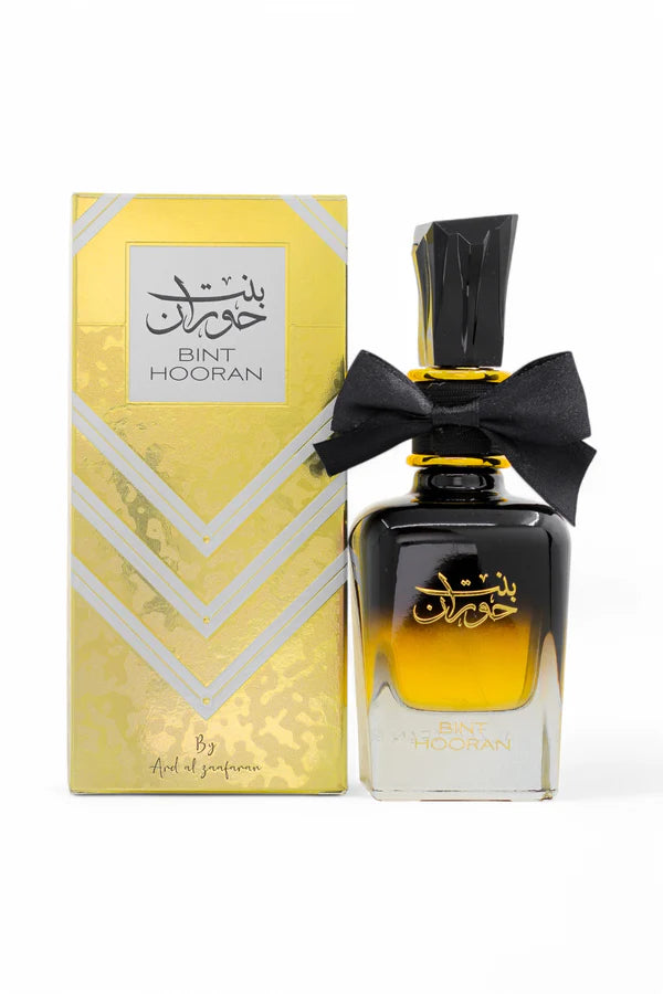 Bint Hooran perfume bottle with yellow packaging on a white background