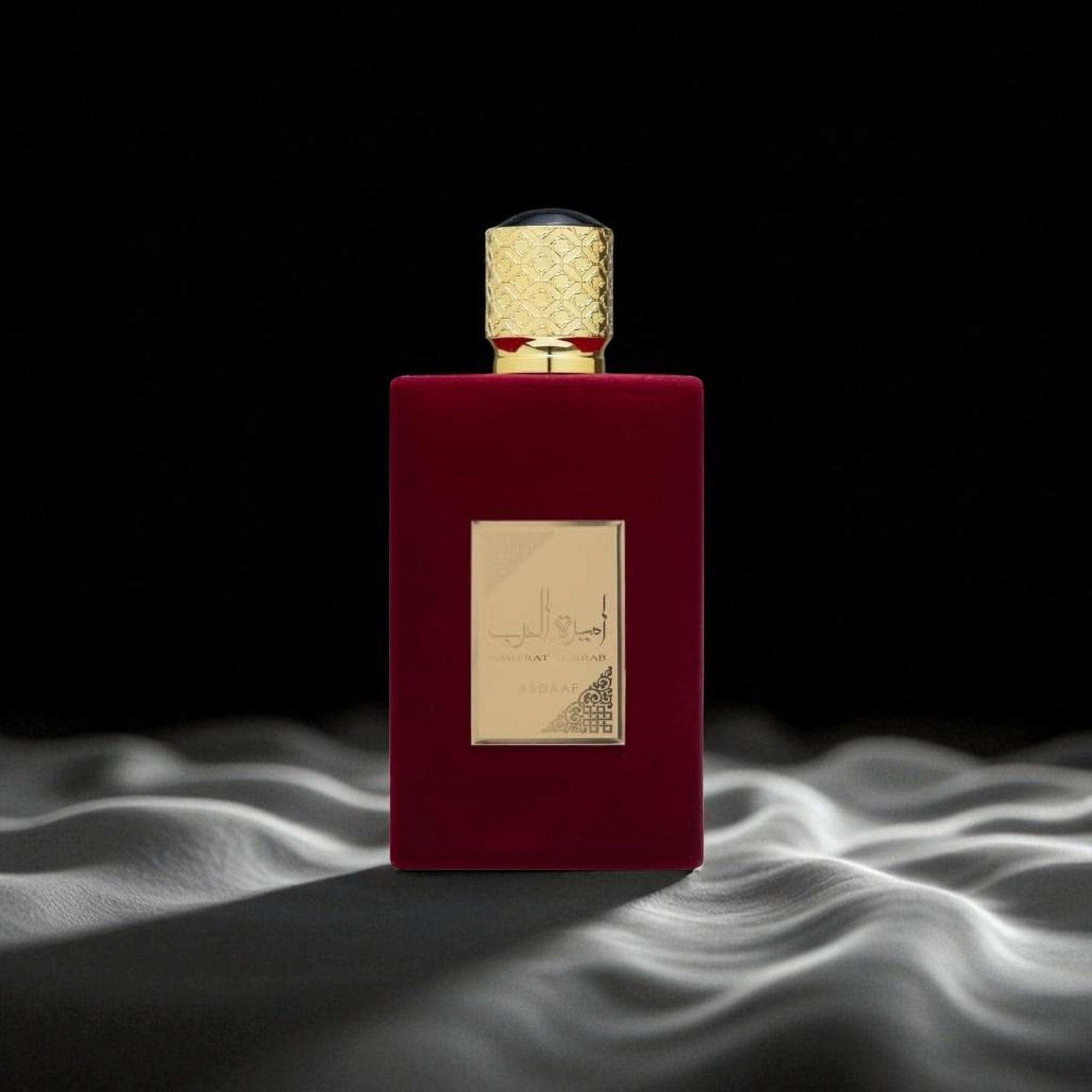 Red perfume bottle with gold cap on a dark background