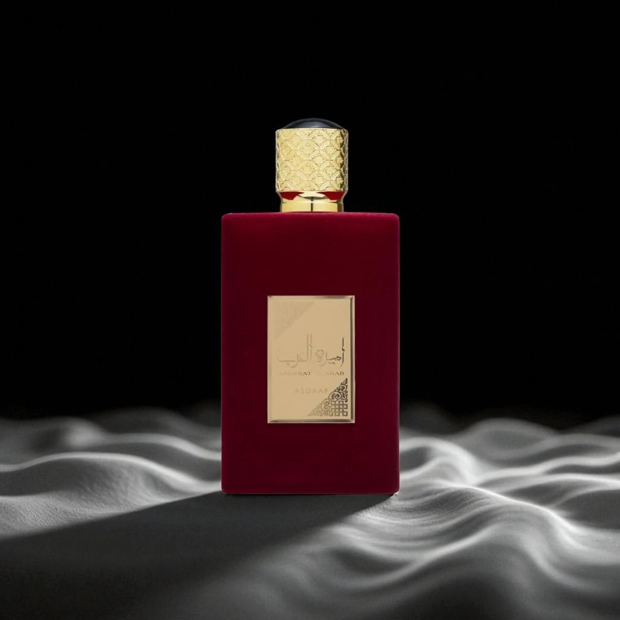 Red perfume bottle with gold cap on a dark background
