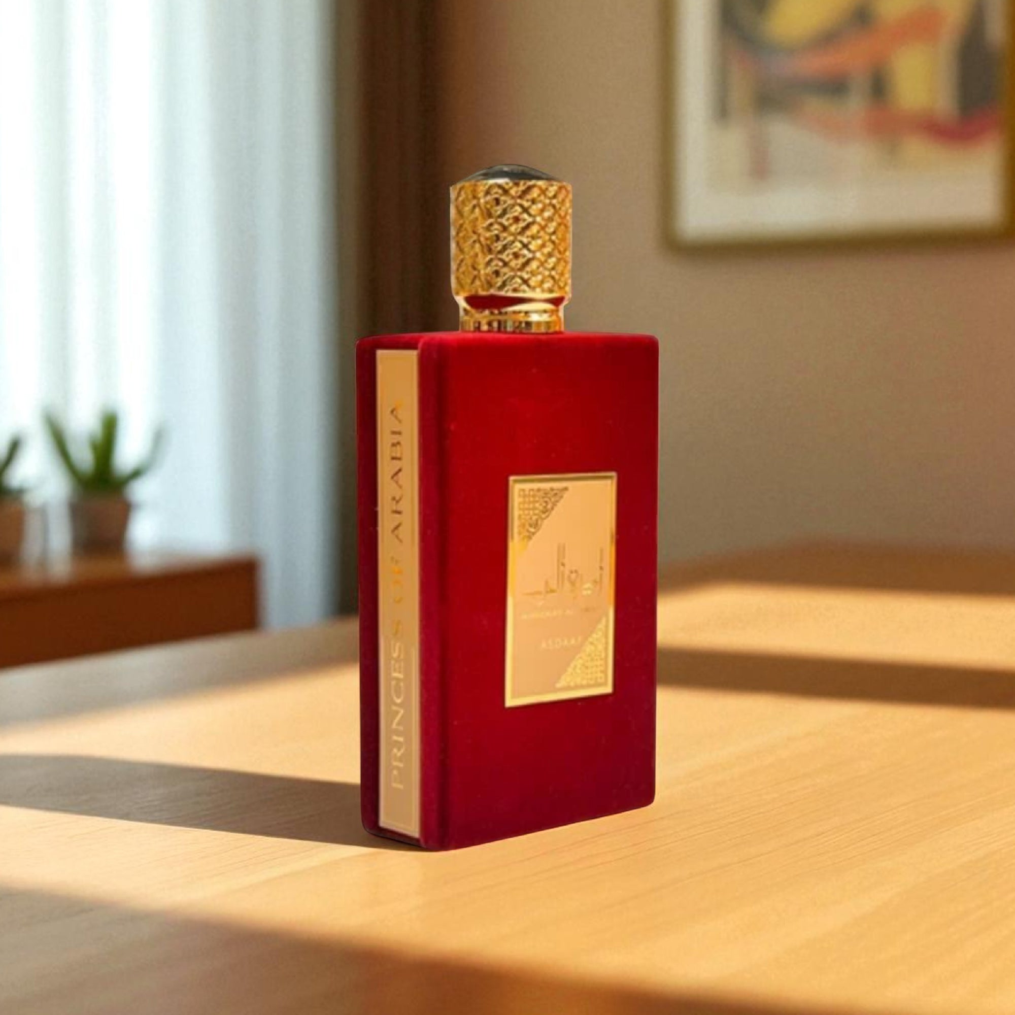 Red perfume bottle with gold cap on a wooden table