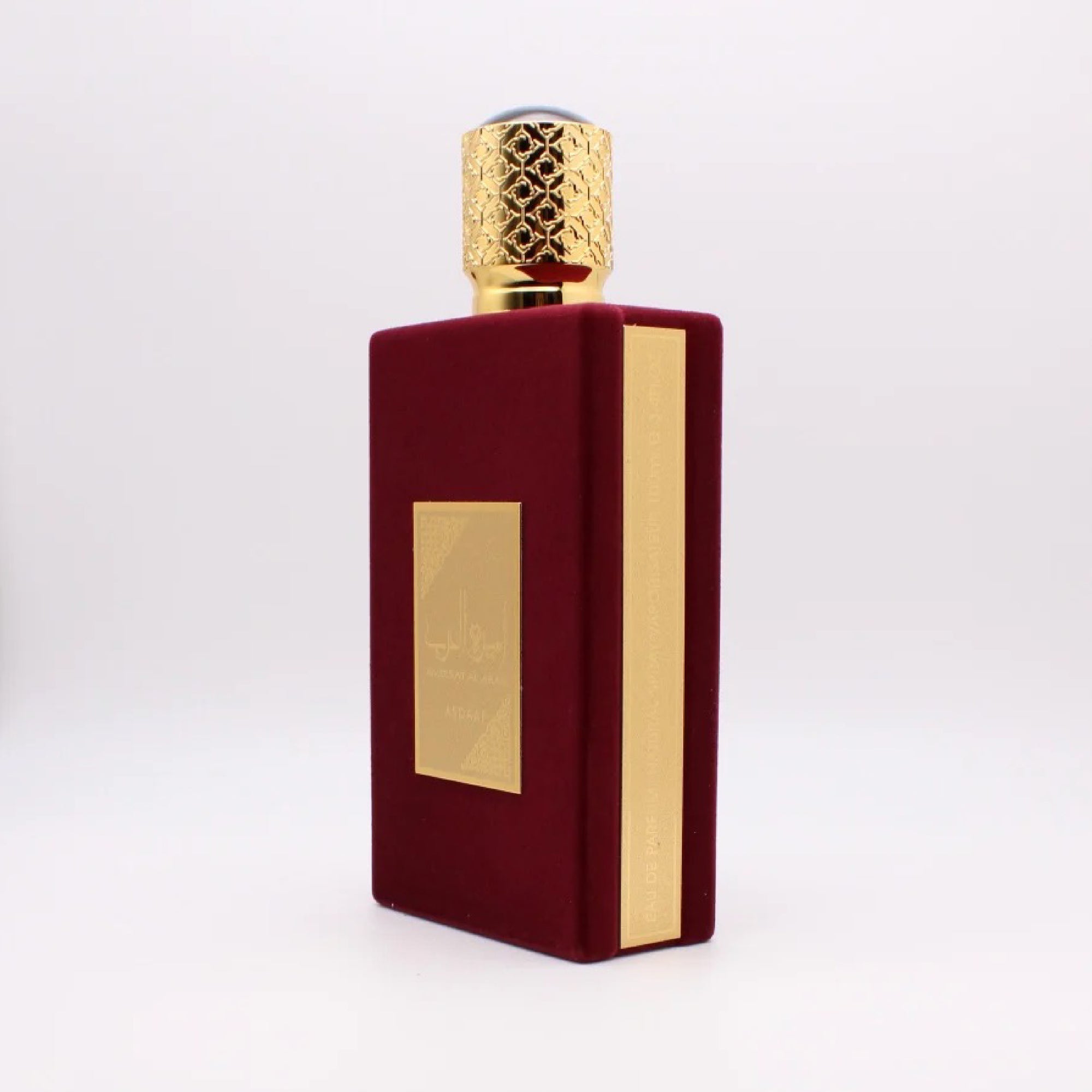 Red and gold perfume bottle on a white background