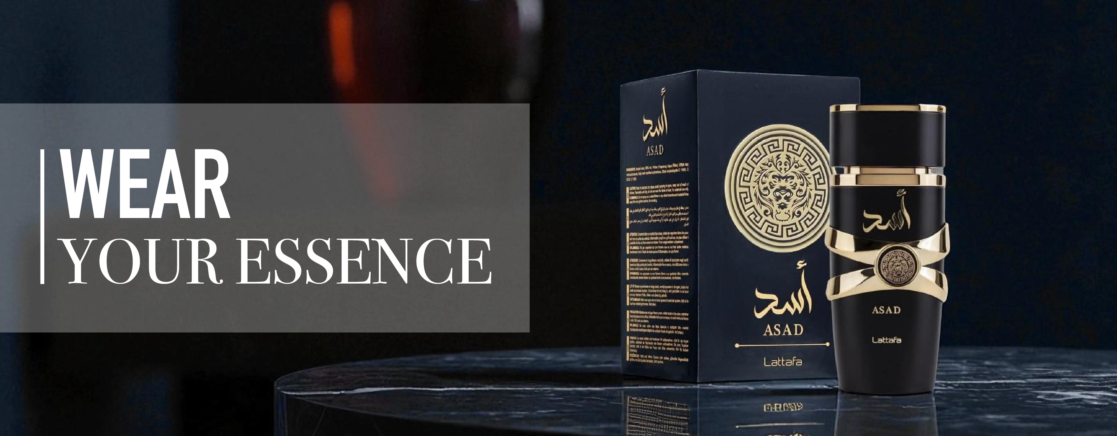 Perfume bottle and packaging with 'Wear Your Essence' text on a dark background