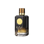 Black perfume bottle with gold cap and label on a white background