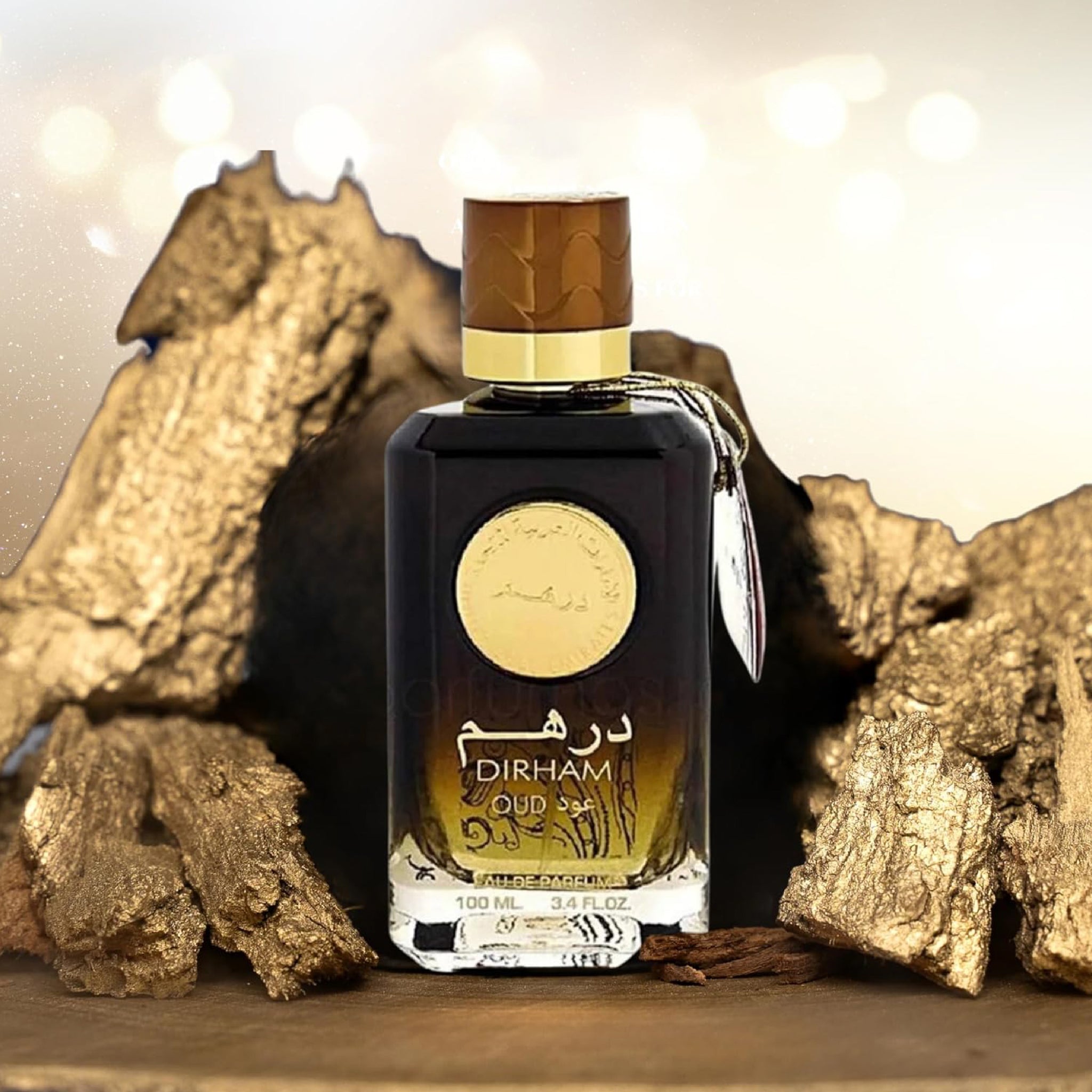 Perfume bottle labeled 'Dirham' with gold accents on a wooden surface.
