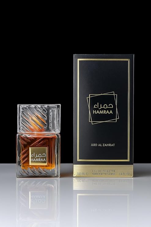 Hamraa perfume bottle and packaging on a reflective surface with a black background