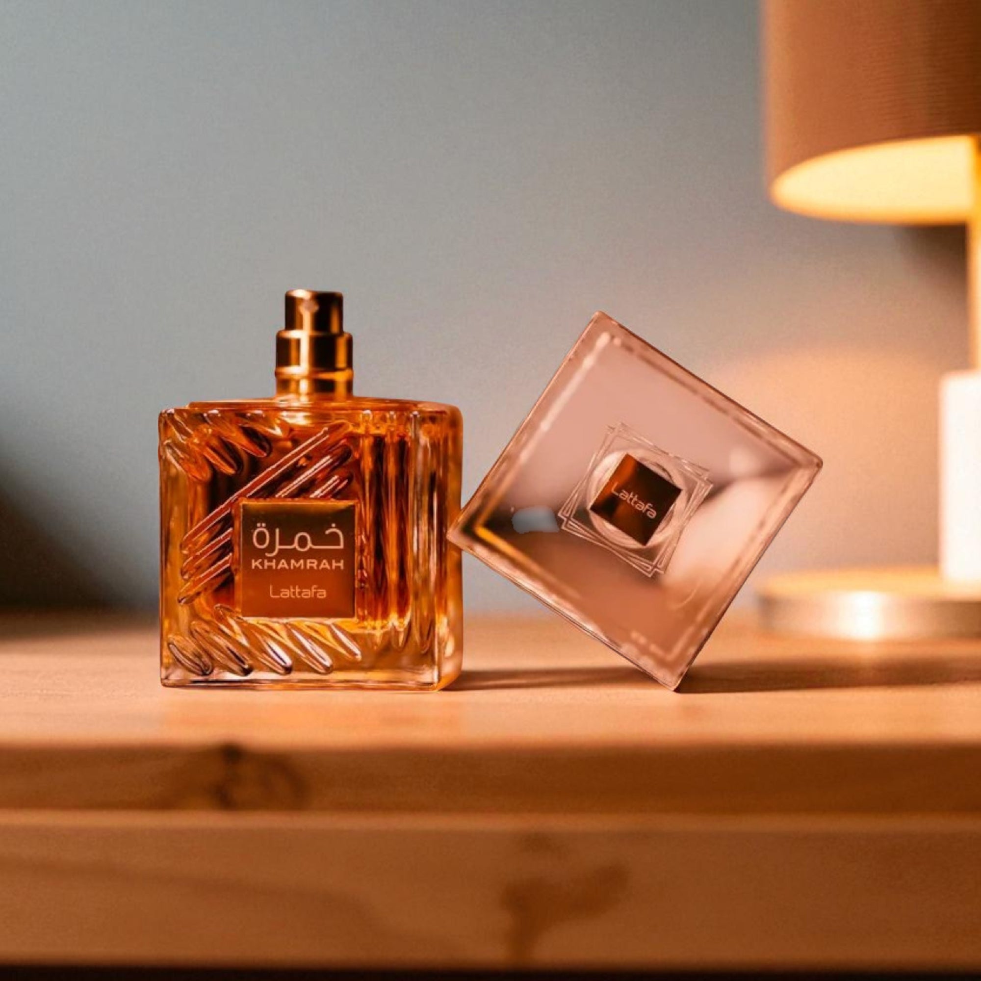 Perfume bottle and its packaging on a wooden surface with a soft background
