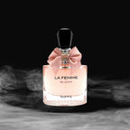Perfume bottle labeled 'La Femme Bloom' by Riiffs with a pink bow on a dark background