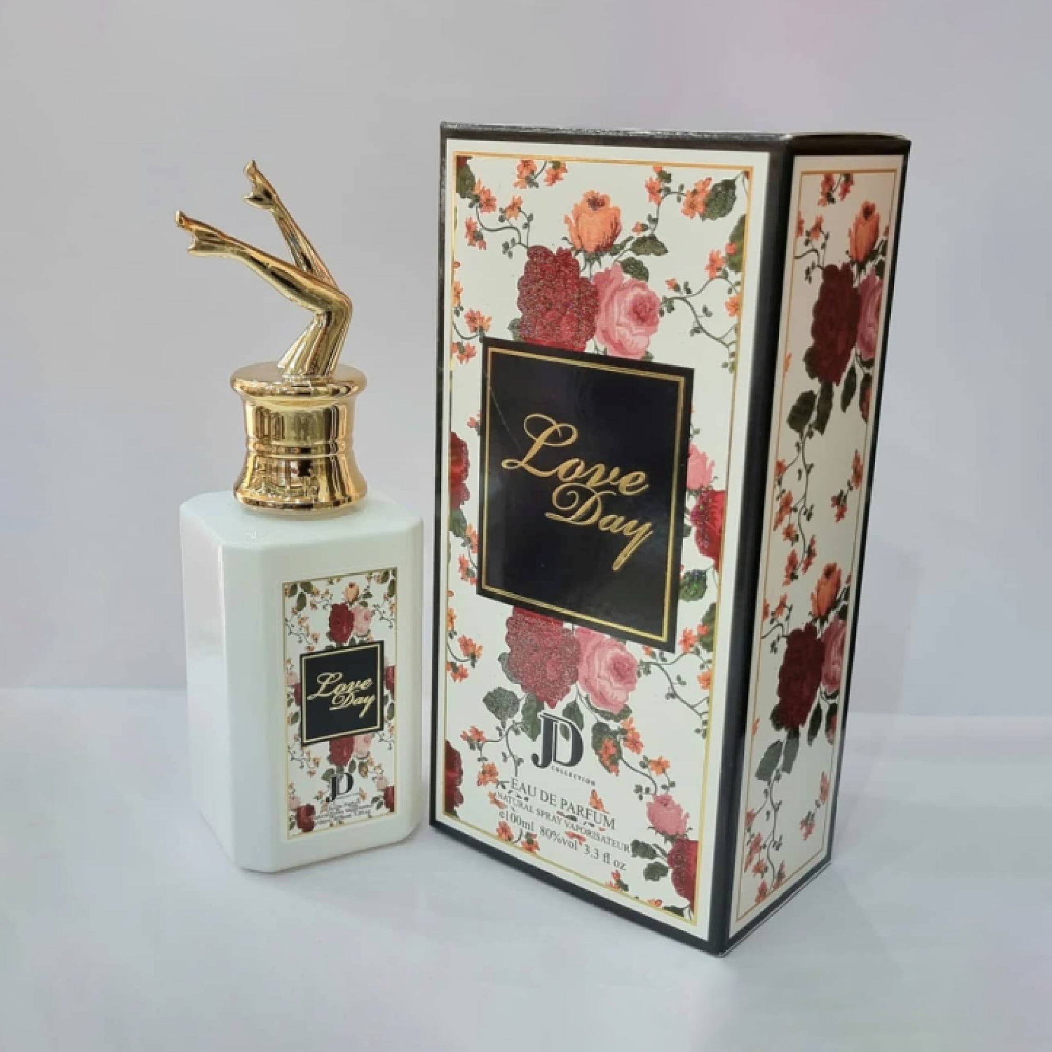 Perfume bottle and packaging with floral design and 'Love Day' text on a white background