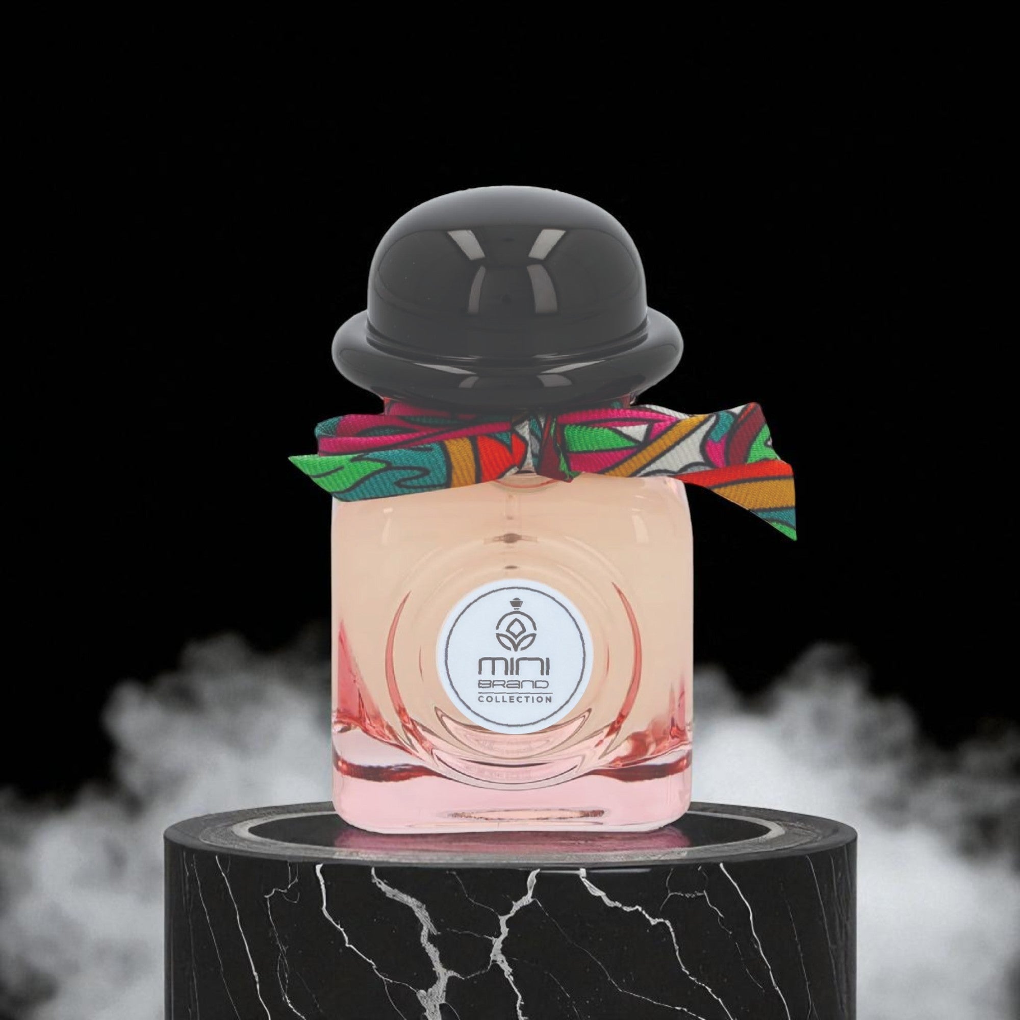 Perfume bottle with colorful ribbon on a black marble stand against a dark background