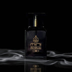 Black perfume bottle with gold accents on a dark background