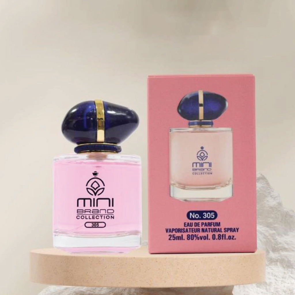 Pink perfume bottle with blue cap and matching box on a beige surface