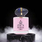 Pink perfume bottle with gold cap on a black marble stand against a dark background