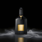 Black perfume bottle with gold accents on a dark background