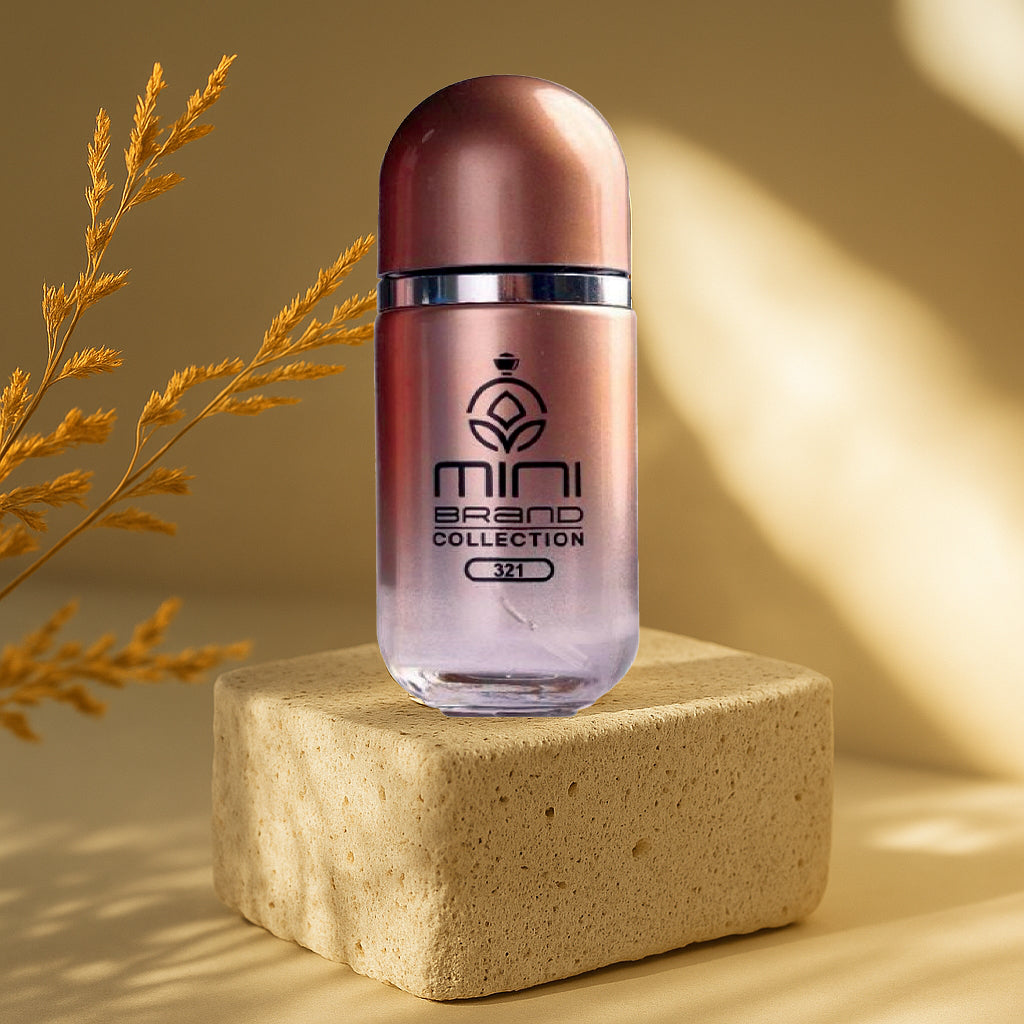 Rose gold bottle with 'mini brand collection' on a beige block against a warm background