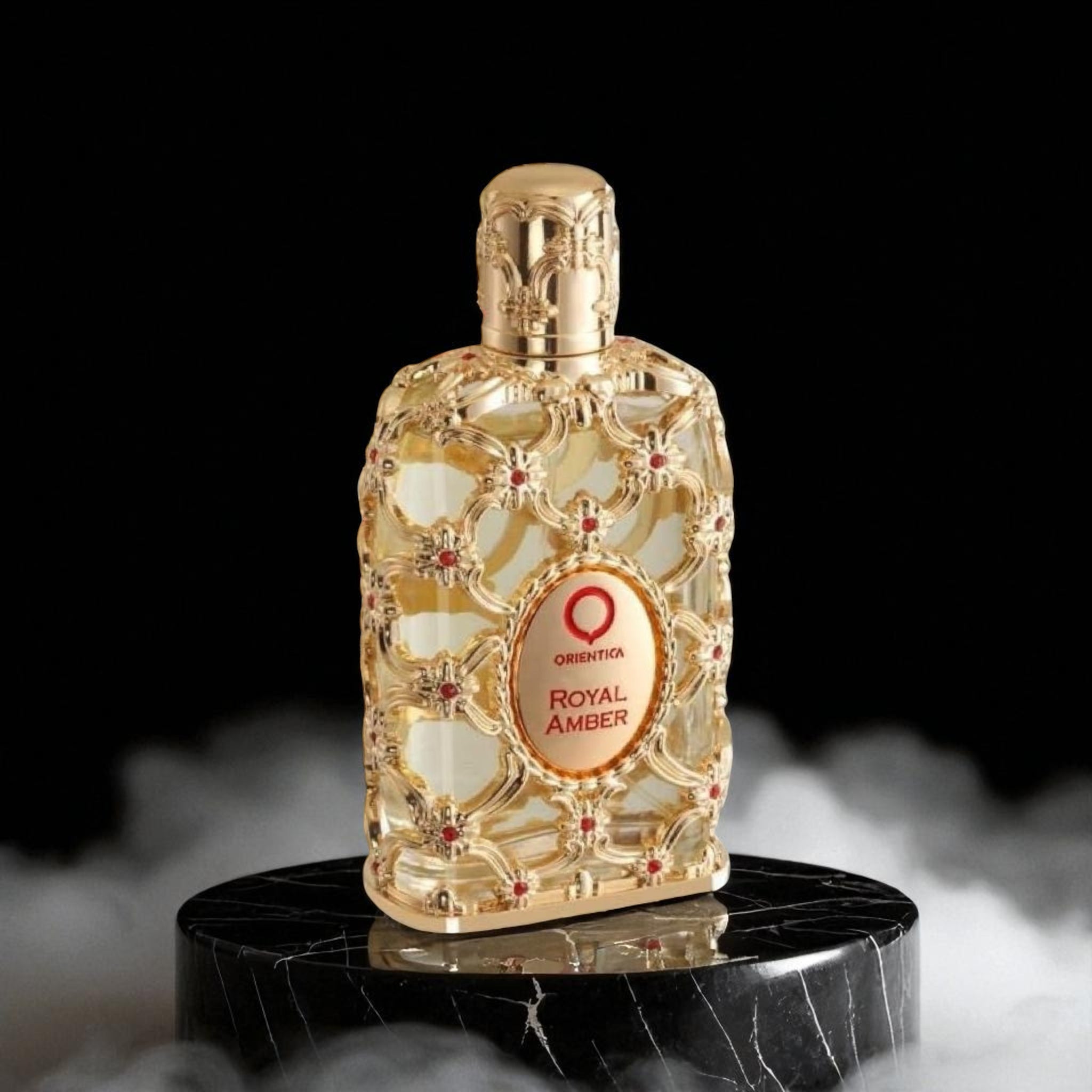 Gold perfume bottle labeled 'Royal Amber' on a dark background