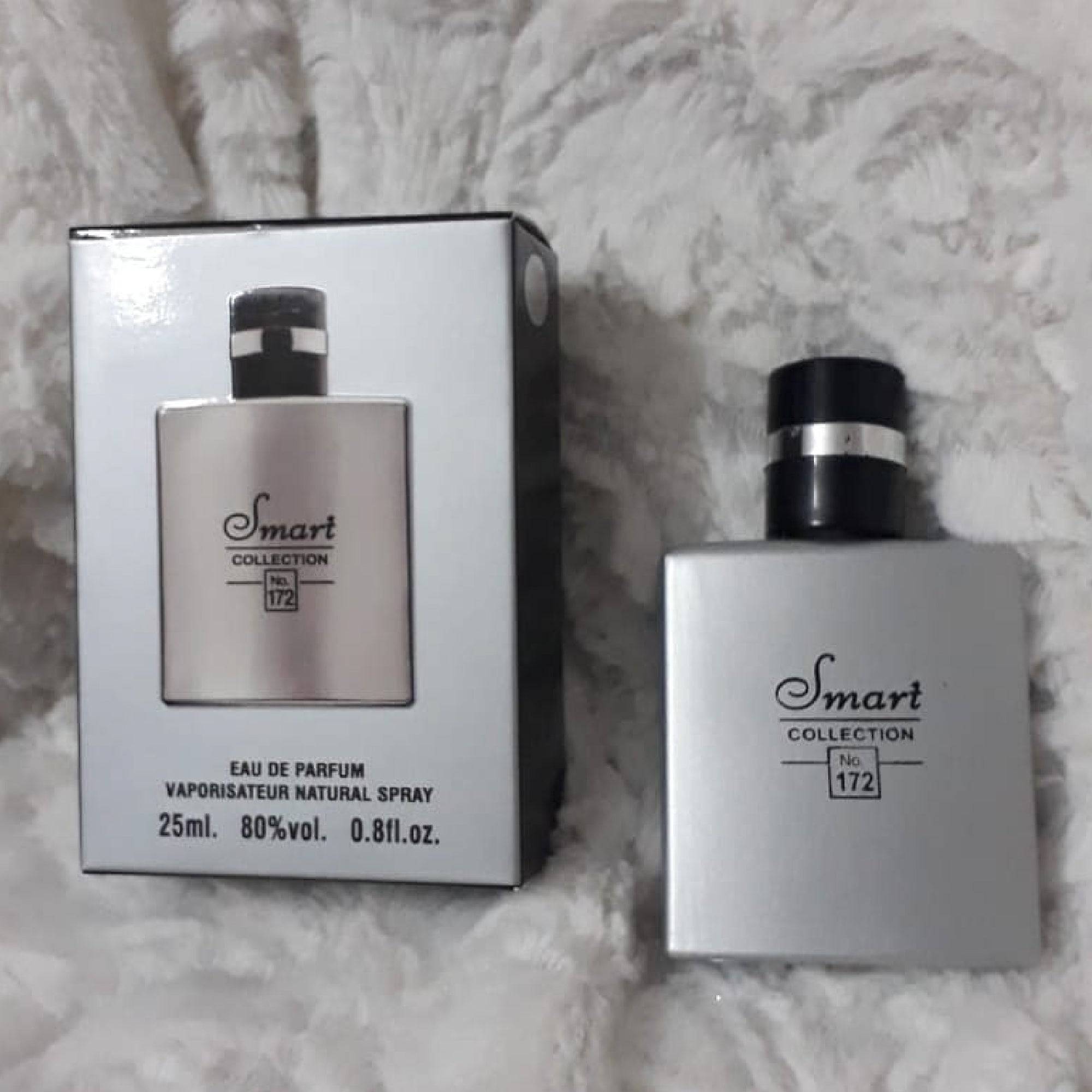 Smart Collection perfume bottle and packaging on a textured surface