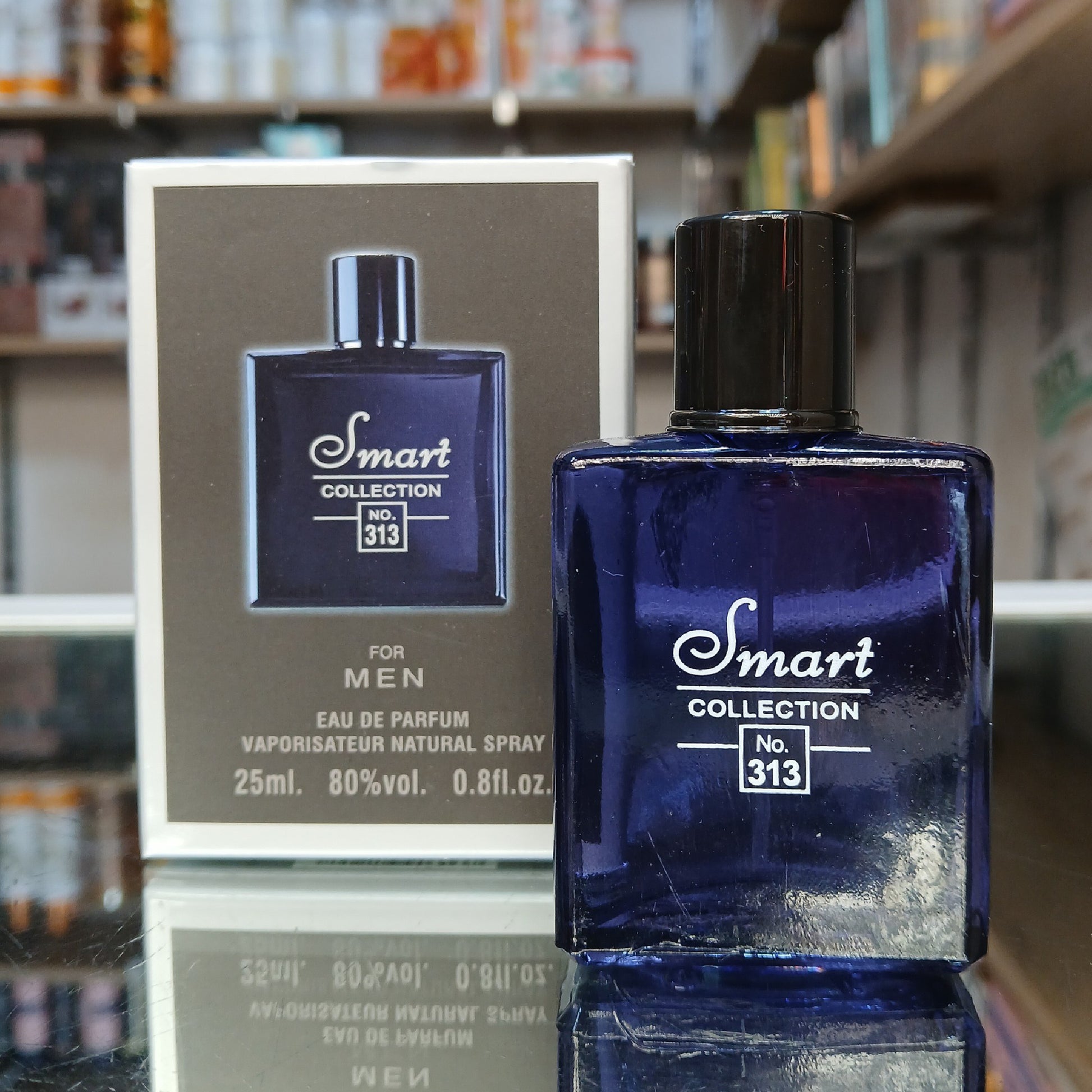 Blue perfume bottle and packaging with 'Smart Collection' branding on a blurred store shelf background.