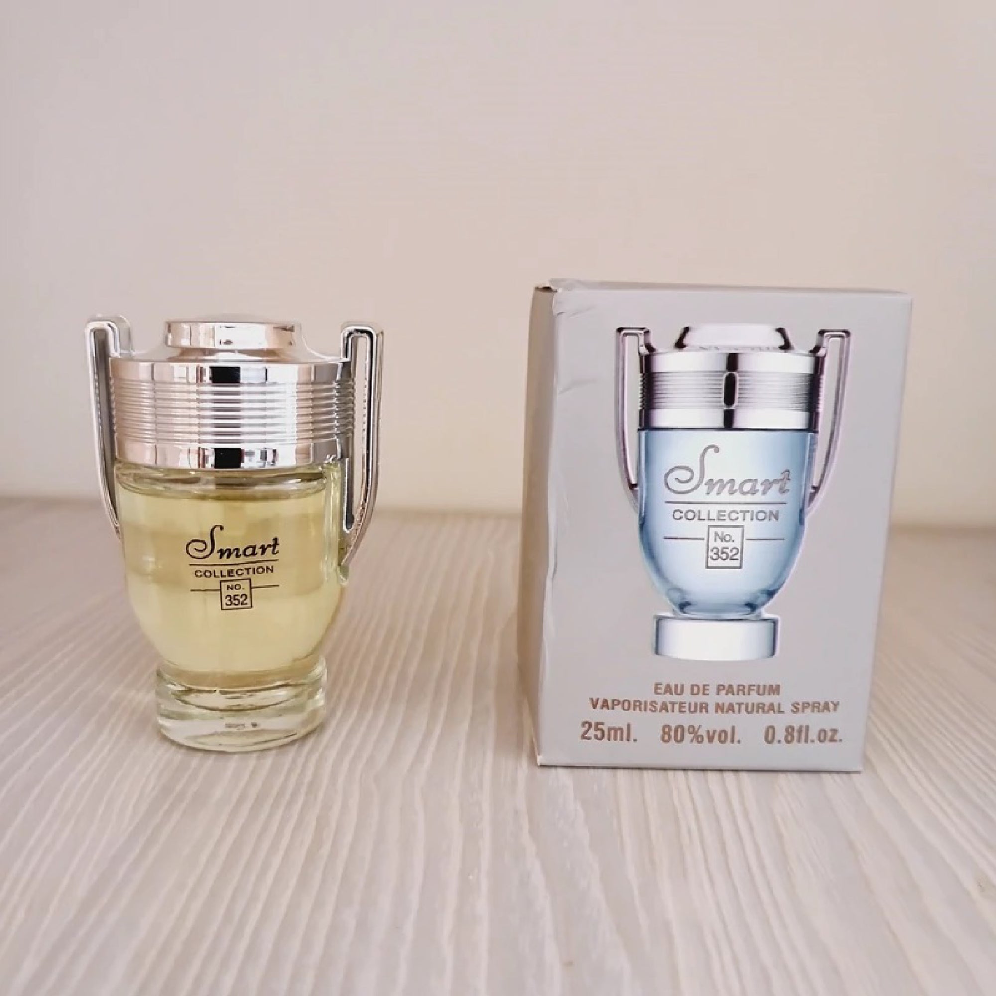 Perfume bottle and packaging of 'Smart Collection' on a light surface.