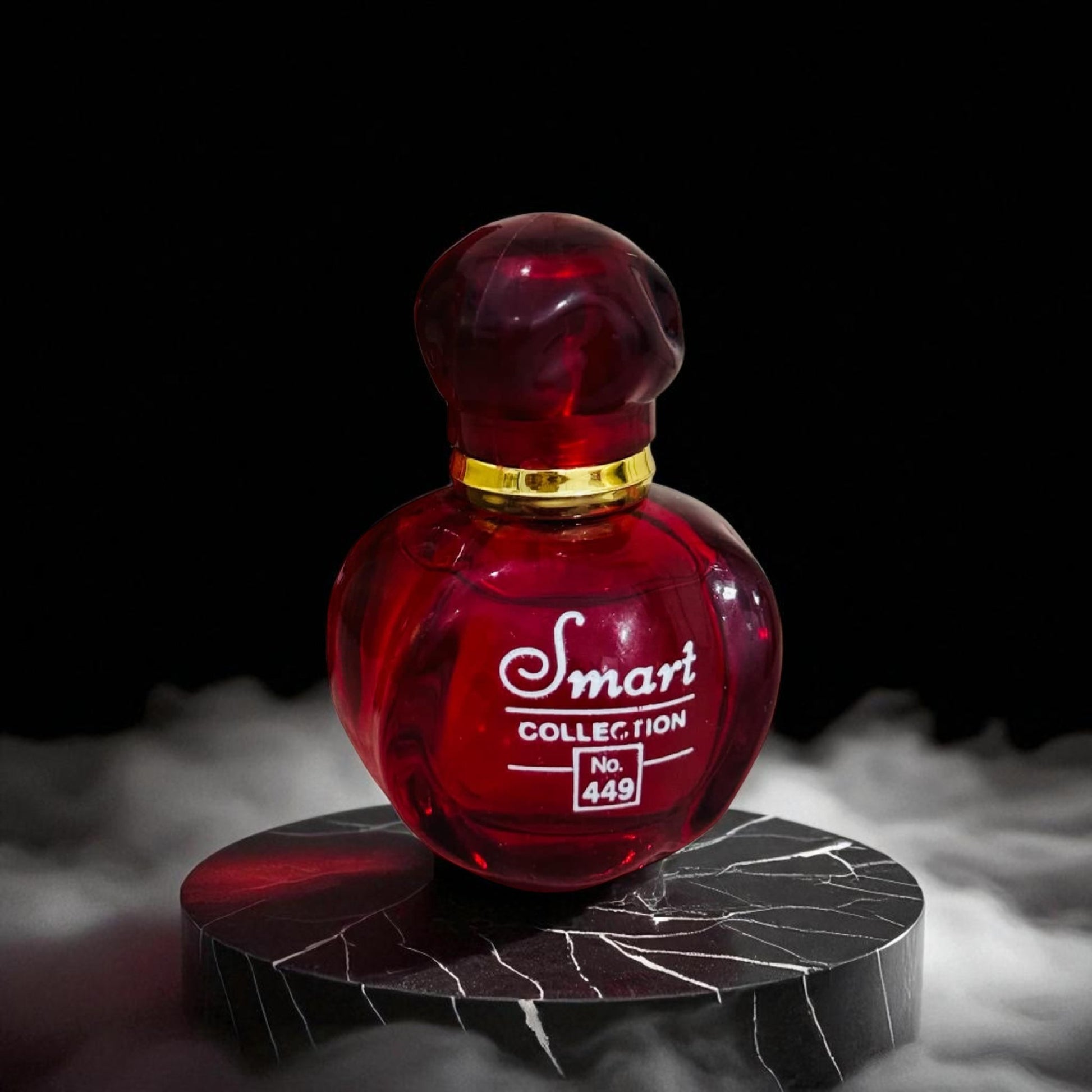 Red perfume bottle with gold cap on a dark background