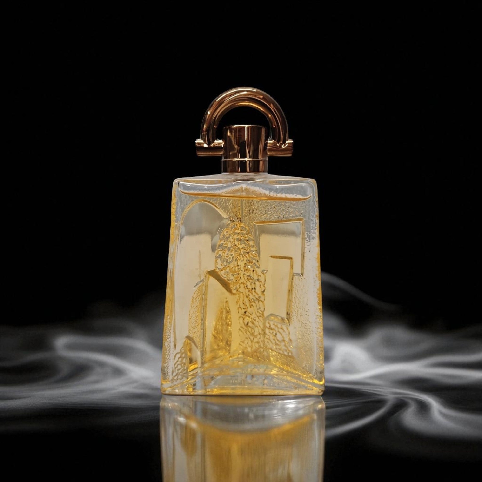 Gold perfume bottle with intricate design on a black background