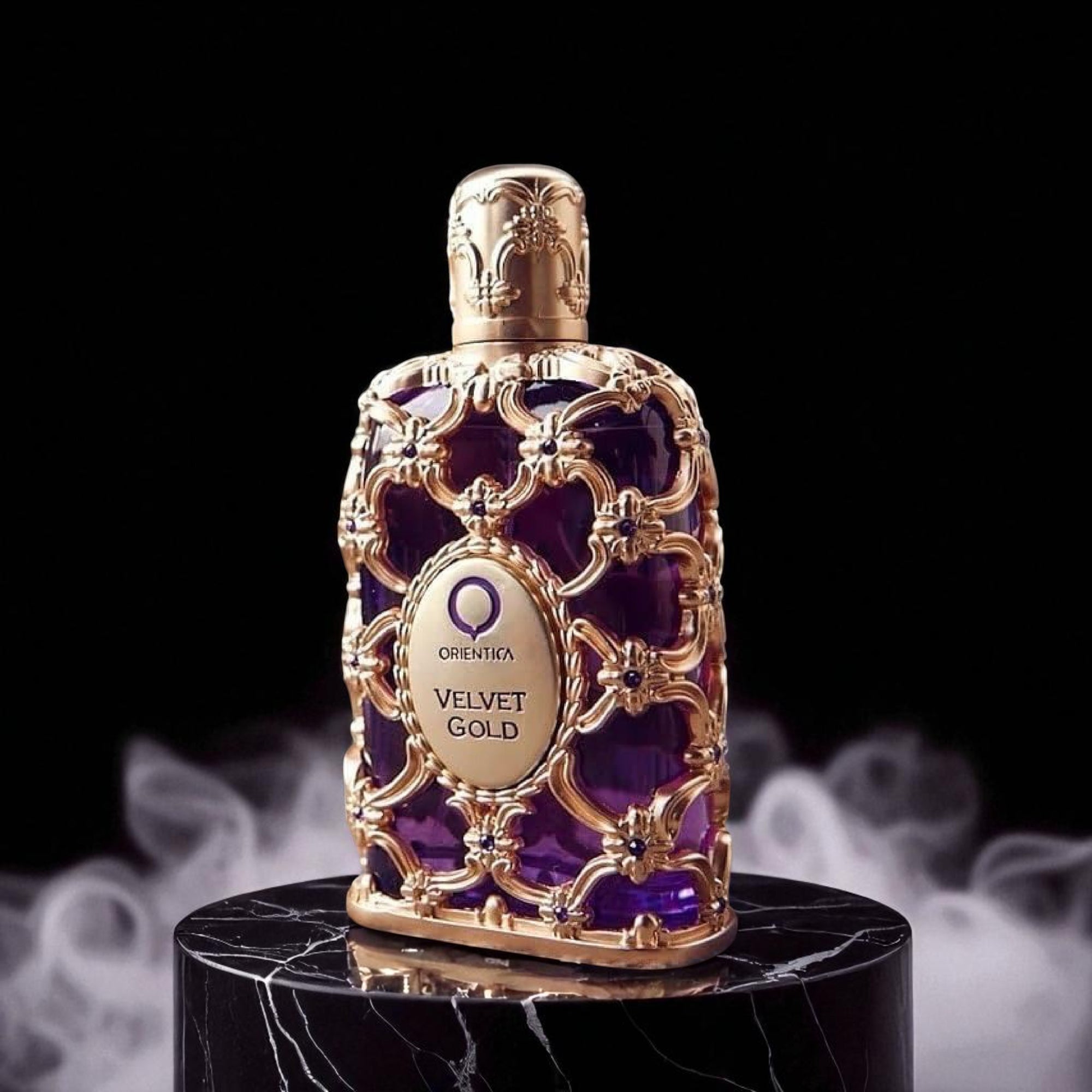 Oriflame Orienta Velvet Gold perfume bottle on a dark background with smoke effect