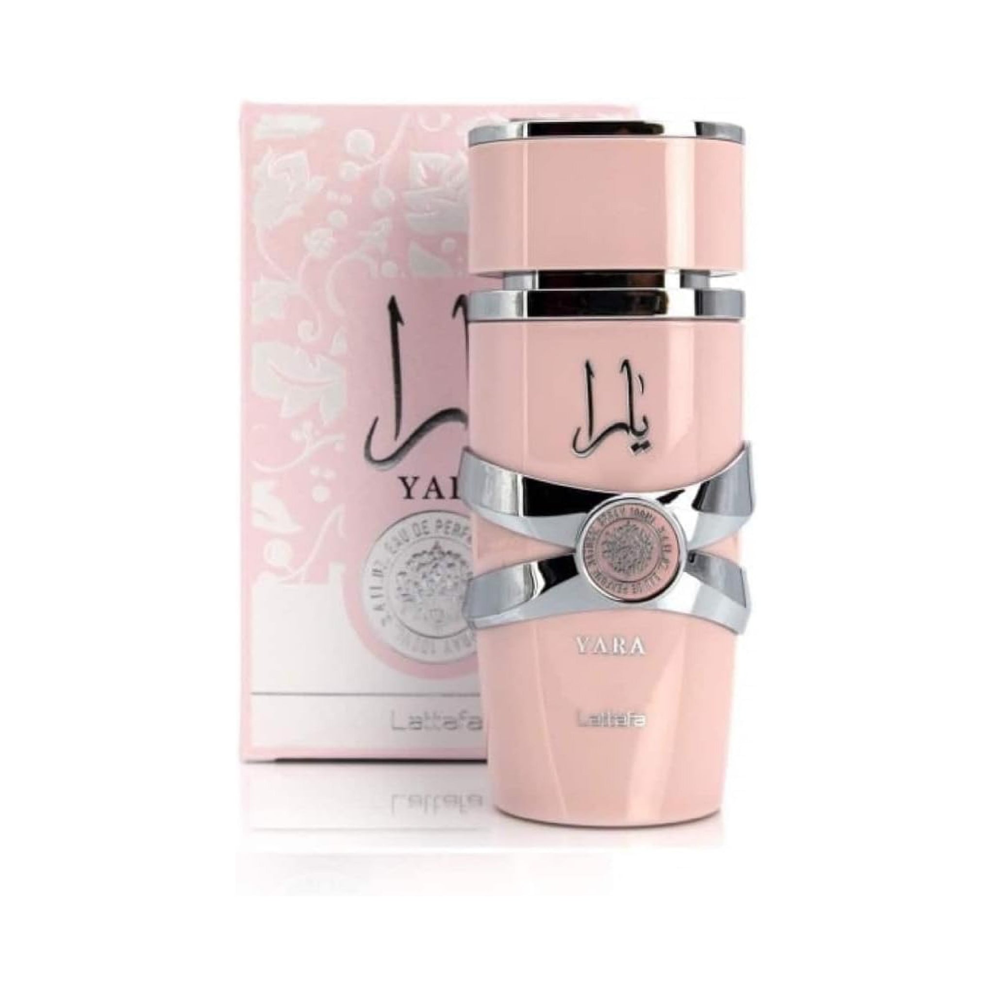 Pink perfume bottle with silver accents and matching box on a white background