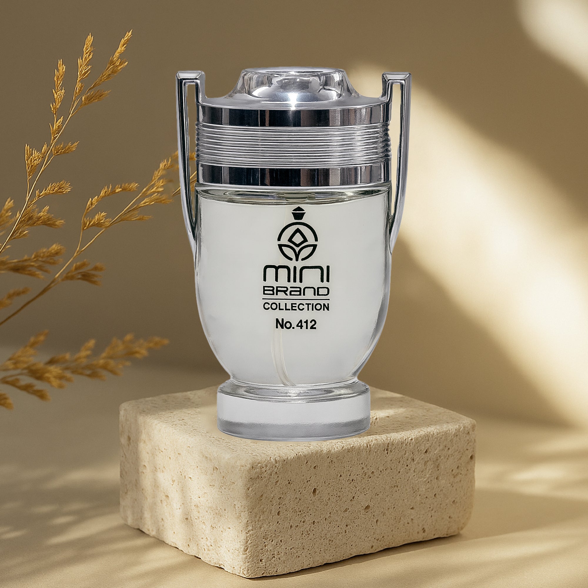 Clear glass container with silver lid on a beige block, featuring 'mini brand collection' branding.